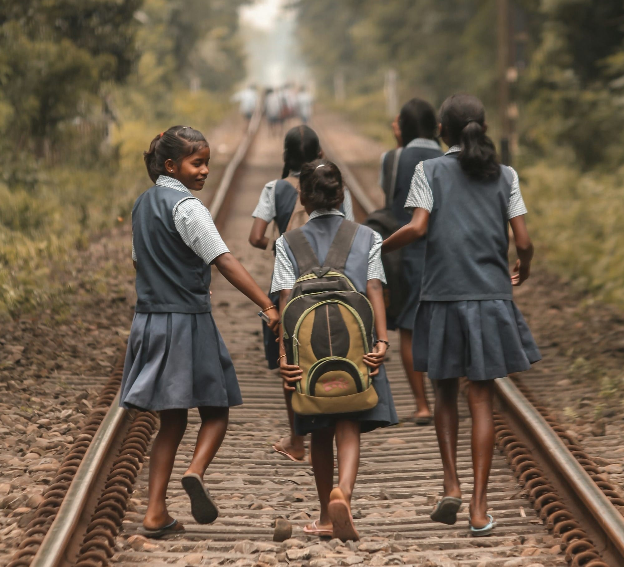 people walking on train rail during daytime
